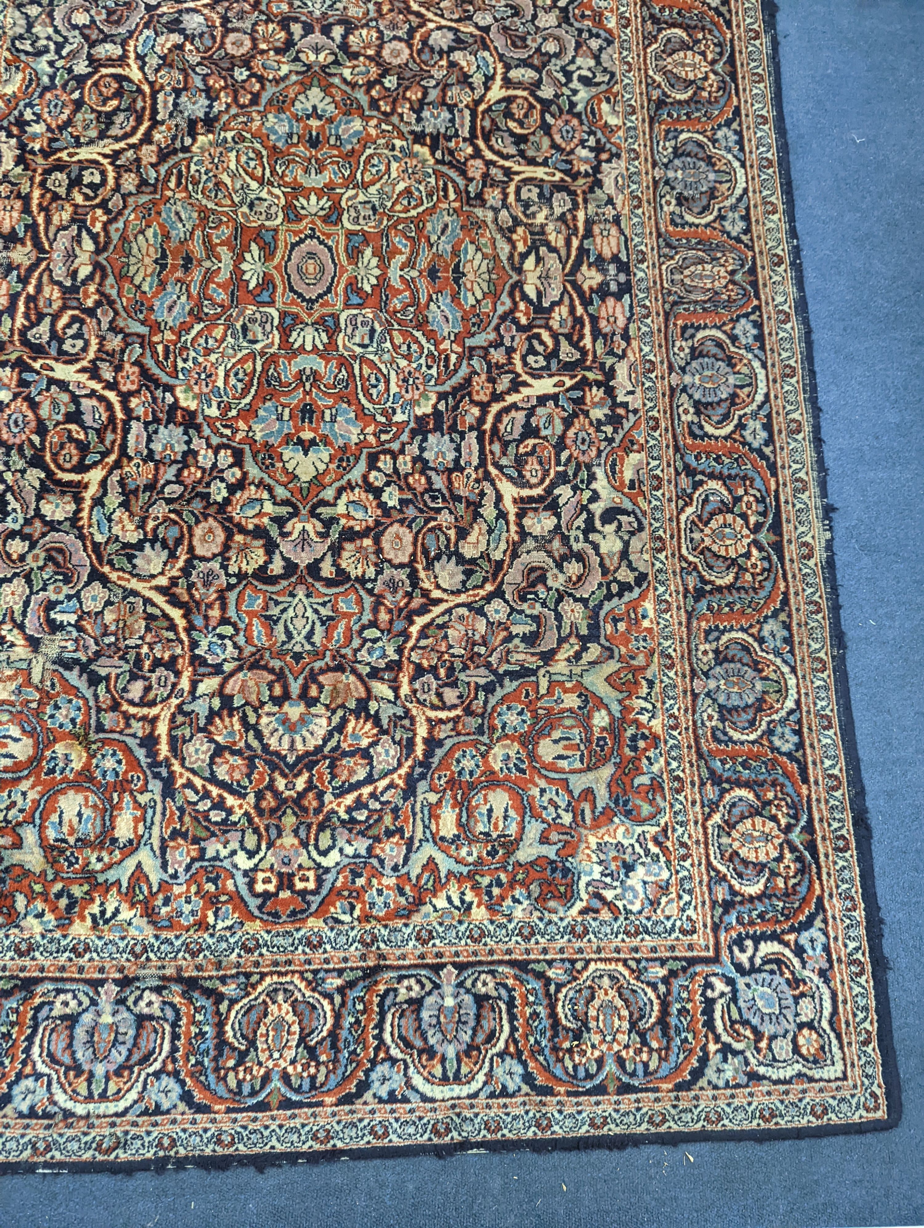 A Kashan blue ground rug, 185x122cm.